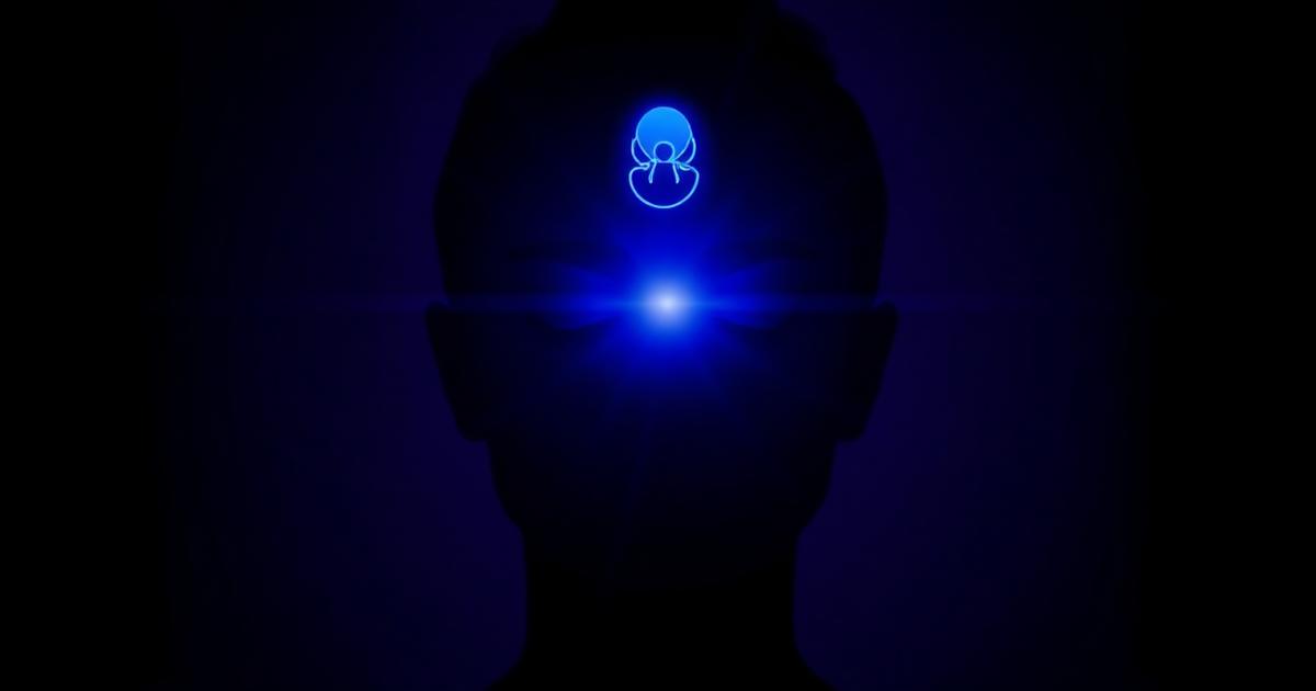 Indigo light glowing at the brow of a calm silhouette against a dark violet background